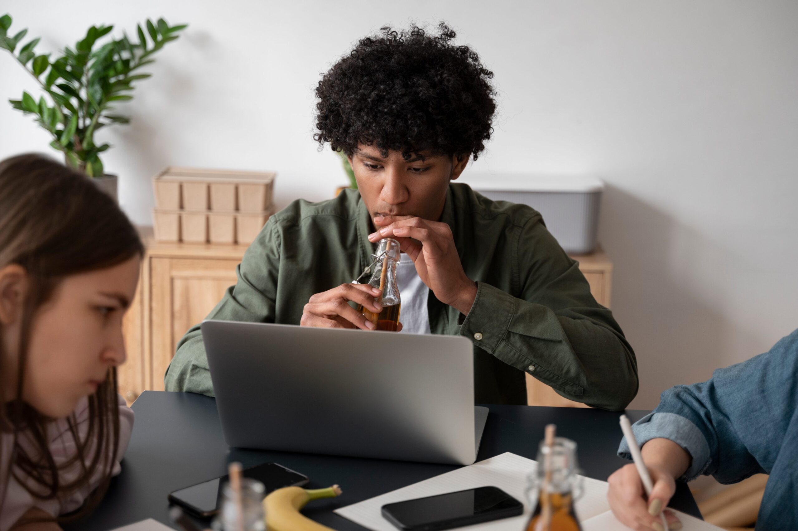 Three young people working together at a laptop