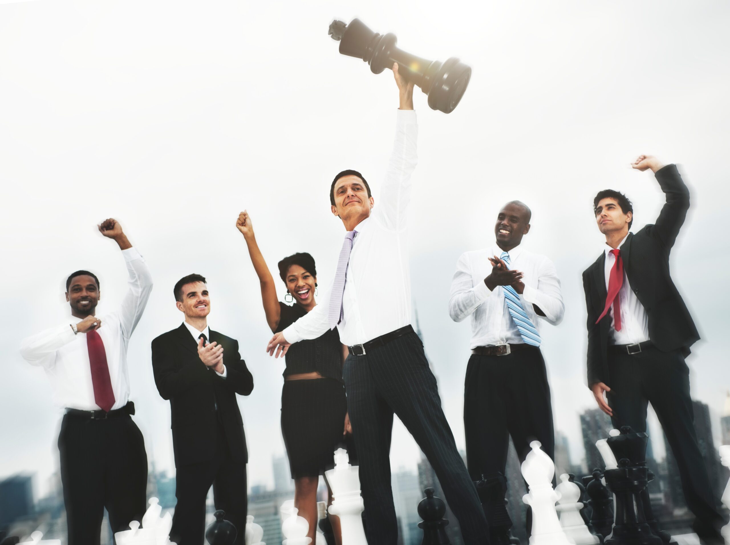 A group of colleagues cheering with their arms raised