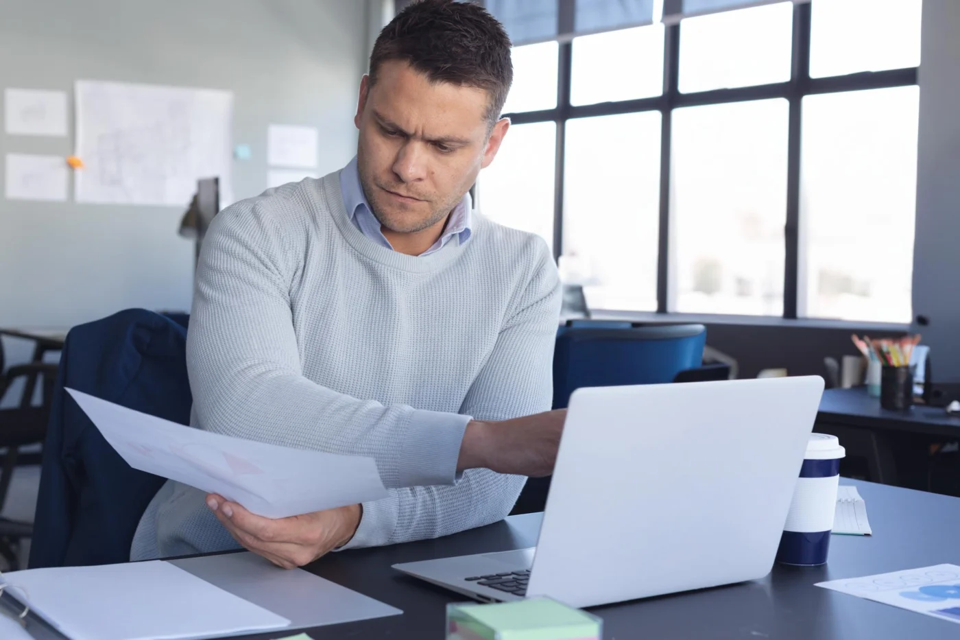 A contractor reviewing a status determination and contract paperwork