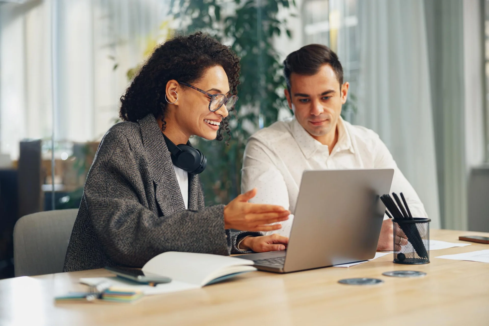 An independent consultant briefing a colleague who will cover a piece of client work
