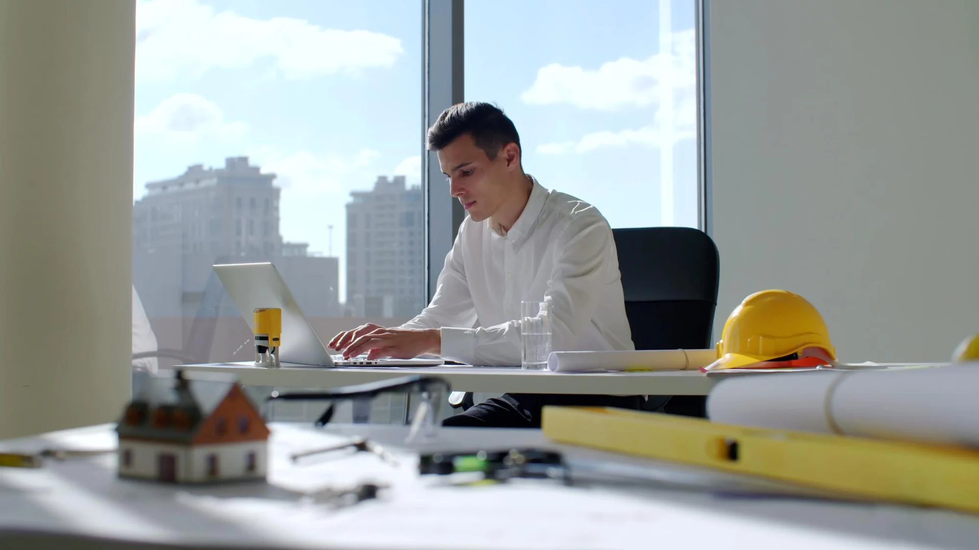 An engineering contractor working independently at a laptop