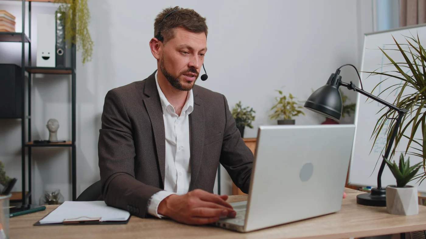 An independent professional working at a laptop, keeping a client's project moving