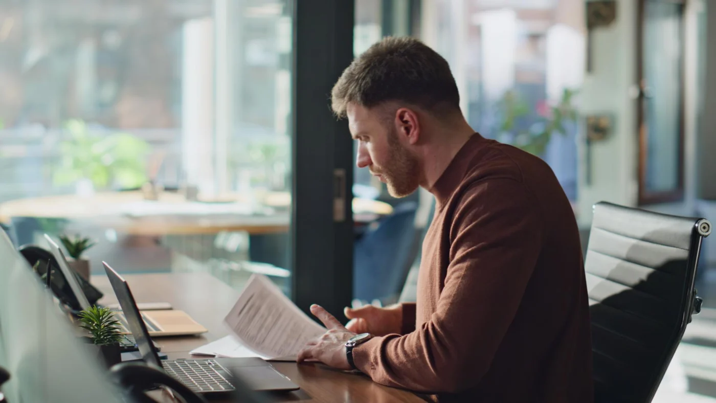 An independent professional running an employment-status check on a laptop