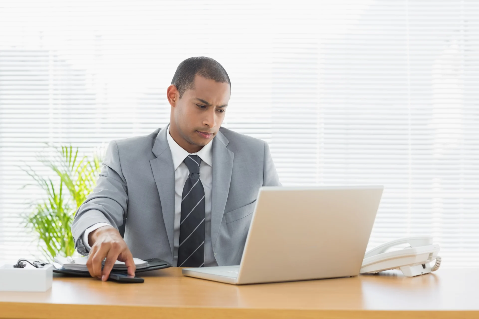 An independent professional running an employment-status check on a laptop