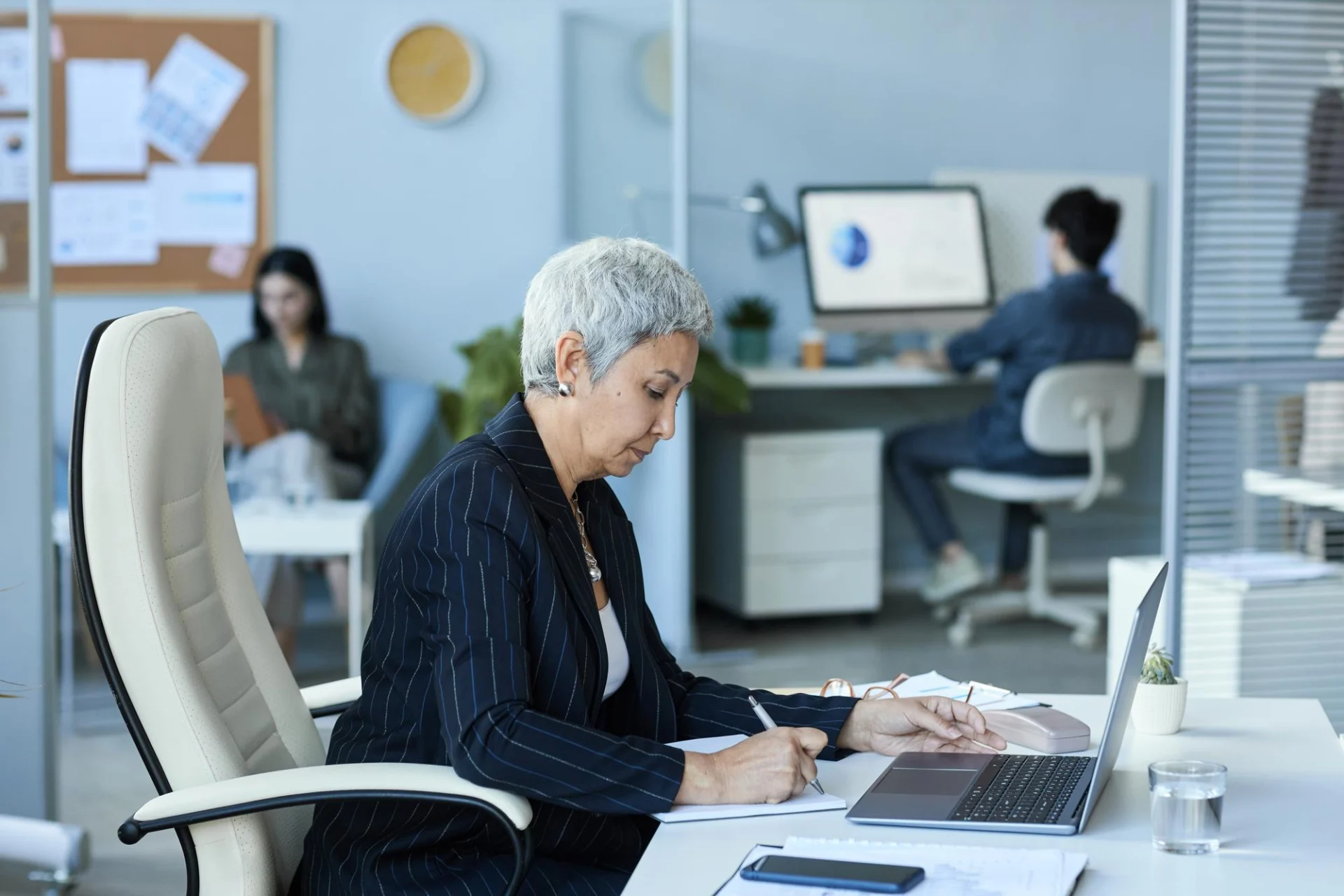 An independent professional working as a one-person firm reviewing a client services agreement at a desk