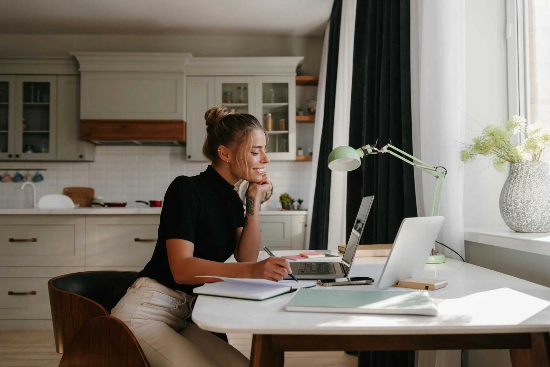 An independent professional at a desk reviewing an overdue B2B invoice and a payment-terms contract