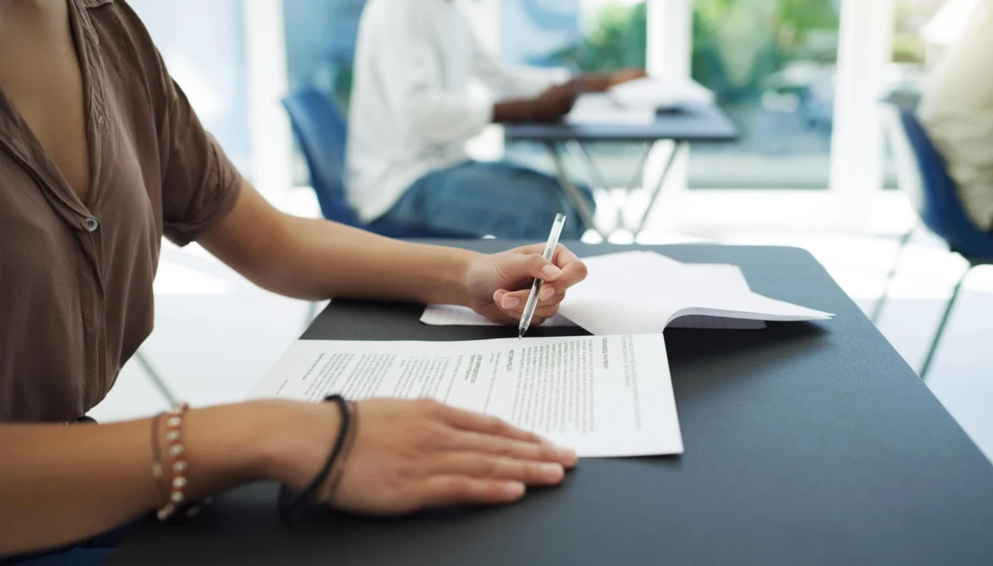 Completing a paper form at a desk