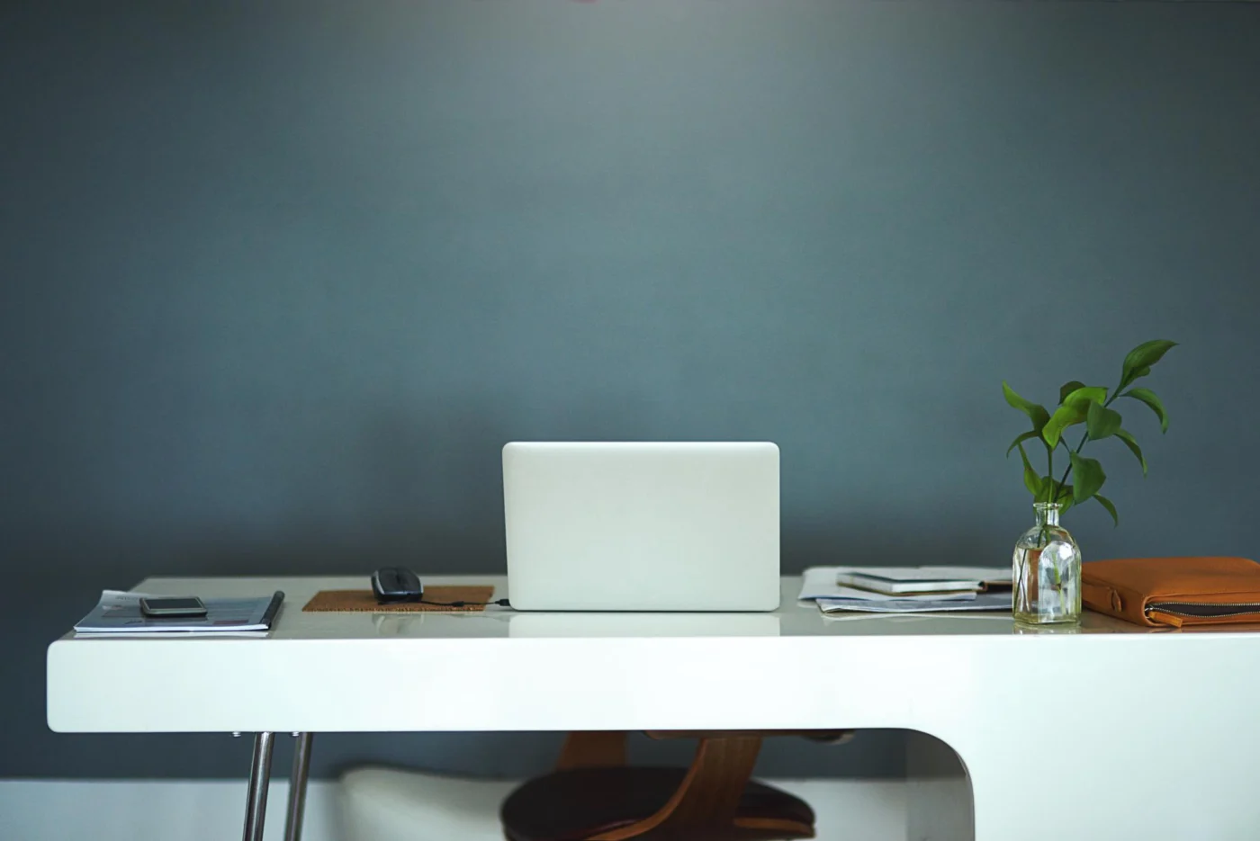 An empty desk and laptop where a single supplier normally works