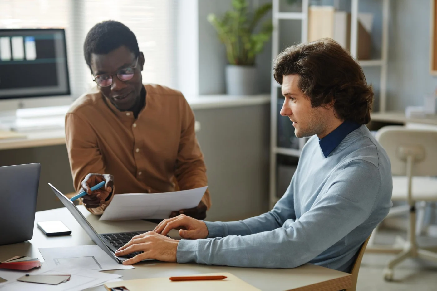 Two independent professionals working through contract documents together